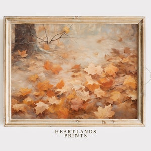 May include: A framed painting of a forest floor covered in fallen autumn leaves. The leaves are shades of orange, yellow, and brown. The painting is in a light wood frame.
