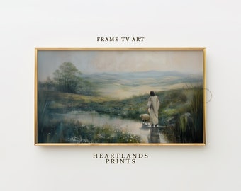 May include: A framed painting depicting a man in a white robe walking through a field with a lamb. The scene is set in a rural landscape with a pond and green grass. The painting has a soft, muted color palette.