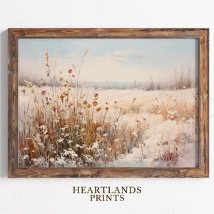 May include: A framed painting of a snowy field with tall grasses and a few pink flowers. The painting has a rustic wooden frame.