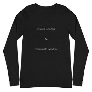 May include: Black long-sleeve shirt with the text "Attached to nothing" above the Om symbol and "Connected to everything" below. The shirt is a solid black color.