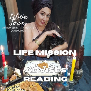 May include: A woman wearing a black headscarf and a black top holds a black and white cat. The woman is sitting at a table with a Ouija board, candles, and other occult items. The text "LIFE MISSION ADVISES READING" is written in white letters on a black background.