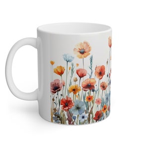 a white coffee mug with colorful flowers on it