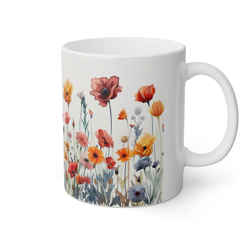 a coffee mug with a painting of flowers on it