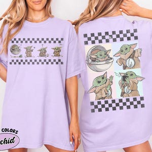 May include: A light purple t-shirt featuring a cartoon character in various poses, with a black and white checkered pattern. The shirt has the text "COMFORT COLORS Orchid" in a circular design.