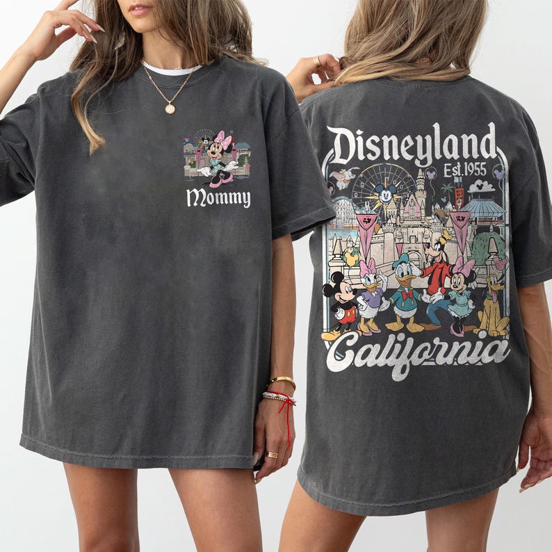 May include: Dark gray t-shirt featuring a Minnie Mouse graphic with the word "Mommy" on the front. The back of the shirt displays a Disneyland graphic with various Disney characters and the text "Disneyland Est. 1955 California."