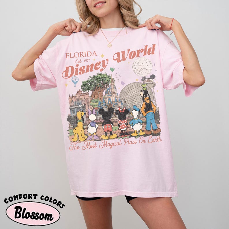 May include: A white ceramic mug with a black handle and the text "But First, Coffee" in a black, handwritten-style font. The mug is on a white surface.