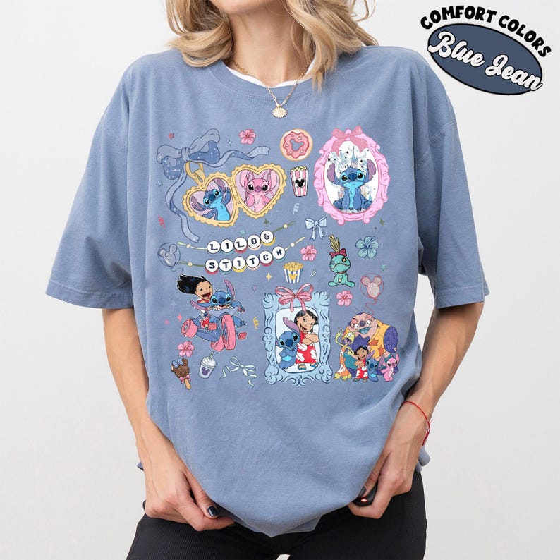 May include: Blue jean-colored t-shirt featuring multiple cartoon images of Stitch. The shirt has a crew neck and short sleeves. The graphic includes the text "Lilo & Stitch" and other cartoon elements. The shirt is labeled "Comfort Colors".