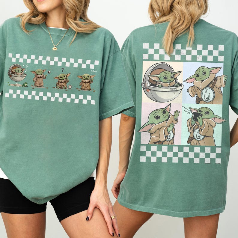 May include: A sage green t-shirt featuring a series of Grogu illustrations with a white and black checkered pattern. The front of the shirt displays Grogu in various poses, while the back showcases four Grogu images.