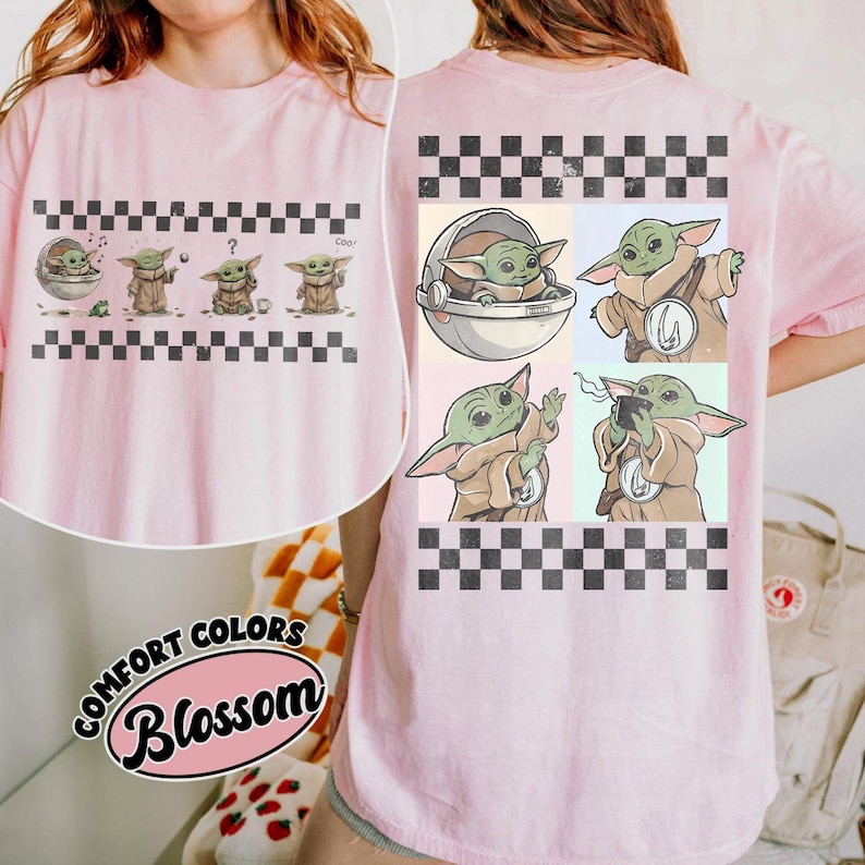 May include: Pink t-shirt featuring a graphic of a character from a popular science fiction series. The front displays the character in various poses, while the back showcases additional images within a checkered border. The shirt includes the text "Comfort Colors Blossom".