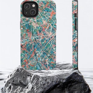 May include: A phone case with a colorful abstract design featuring splashes of blue, green, pink, and white paint. The case is designed to fit a smartphone with a camera bump.