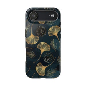 May include: A phone case with a dark teal background and a repeating pattern of gold-colored ginkgo leaves and other botanical elements. The case has a black camera housing and a glossy finish.