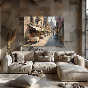 May include: A painting of a narrow street in a European city with outdoor cafes and a church in the distance. The painting is done in a realistic style with warm colors and a sense of depth.