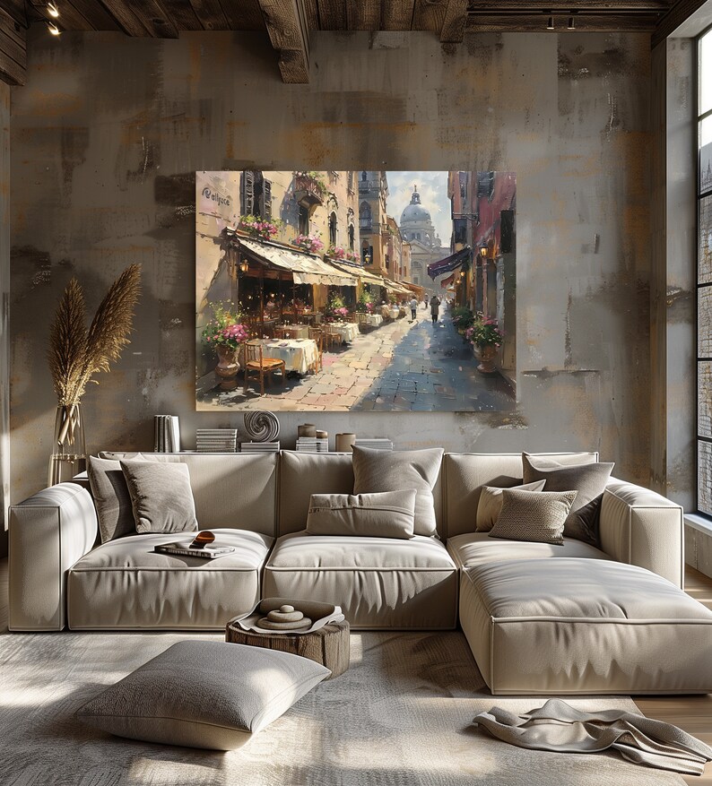 May include: A painting of a narrow street in a European city with outdoor cafes and a church in the distance. The painting is done in a realistic style with warm colors and a sense of depth.