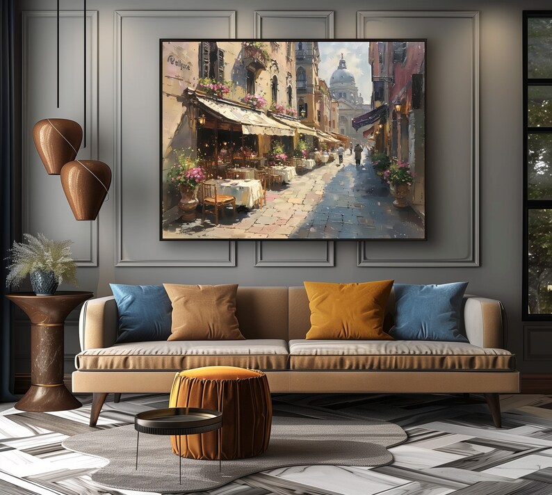 May include: A painting of a street scene in Venice, Italy. The painting features a narrow street lined with buildings, shops, and cafes. There are people walking in the street, and the sky is blue with white clouds. The painting is done in a realistic style, with a focus on detail and light.