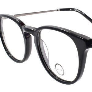 May include: Black plastic framed eyeglasses with a silver metal bridge and arms.