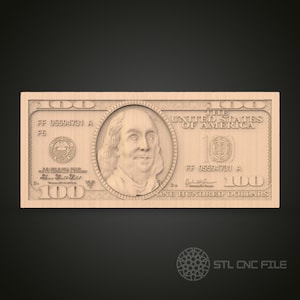 May include: A wood carving of a $100 US bill featuring a portrait of Benjamin Franklin. The bill has the text "THE UNITED STATES OF AMERICA" and "ONE HUNDRED DOLLARS".