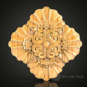 May include: A detailed, symmetrical wooden carving with a central circular design and ornate, swirling patterns. The carving features a light brown color and a textured surface, with a fan-like design around the edges. The text "STL CNC FILE" is visible.