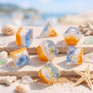 May include: A set of seven polyhedral dice made of clear resin with a layered design featuring orange, white, and blue colours. Each die has white numbers and a textured, sandy appearance inside, resembling a beach scene with waves and sand.