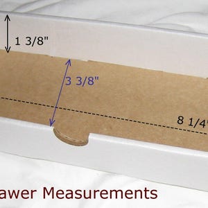 May include: White cardboard box with a brown cardboard insert. The inside dimensions of the box are 8 1/4 inches long, 3 3/8 inches wide, and 1 3/8 inches deep. The text "Inside Drawer Measurements" is printed below the box.