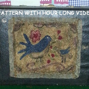 May include: A vintage wooden box with a blue bird and red flowers embroidered on a tan fabric panel. The box has a black leather exterior and the text "EPATTERN WITH HOUR LONG VIDEO" is printed on the top.