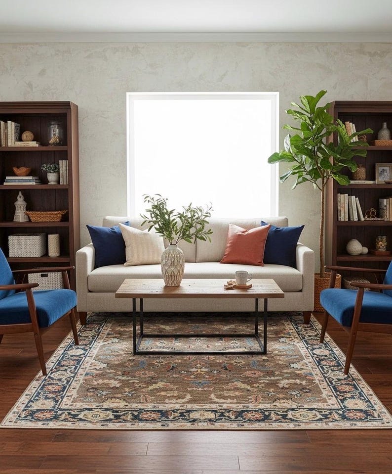 Large 9x12 neutral Oushak rug centered in a bright living room under a wooden coffee table.