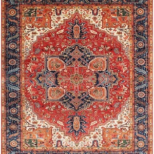 May include: A rectangular area rug featuring a complex central medallion in deep blue and red, surrounded by intricate floral and geometric patterns in cream, orange, and green. The border consists of repeating floral motifs on a dark blue background.