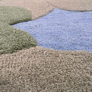 Detailed shot of the sage, forest green, and sky blue wool fibers highlighting the high-quality craftsmanship.