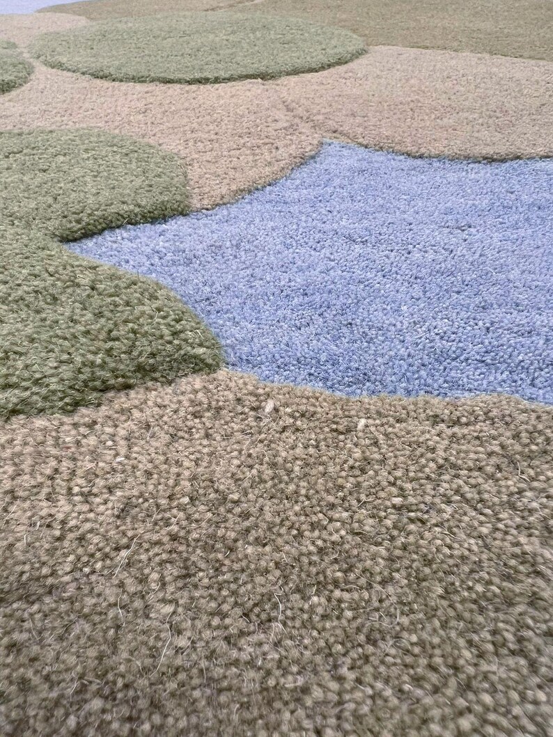 Detailed shot of the sage, forest green, and sky blue wool fibers highlighting the high-quality craftsmanship.