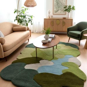 An abstract forest-themed wool rug styled in a bright, modern living room under a coffee table.
