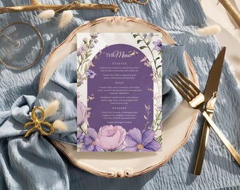 May include: A purple and white wedding menu card with floral illustrations. The menu includes starter, main, and dessert options. The text "The Menu" is written in a decorative font.
