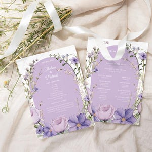 May include: Purple wedding ceremony program with floral designs and the names "Thelma & Patrick" printed on the front. The back of the program lists the order of events for the ceremony.
