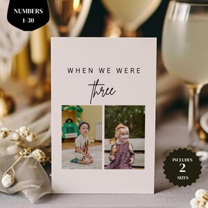May include: A light pink card featuring the text "WHEN WE WERE three" and two photographs of children. The card also includes the text "INCLUDES 2 SIZES" and "NUMBERS 1-30".