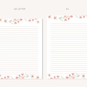May include: Two sheets of lined stationery, one US Letter size and one A4 size, are displayed. Both sheets feature a delicate watercolor floral design of pink blossoms and green leaves at the top and bottom. The paper has horizontal pink lines.