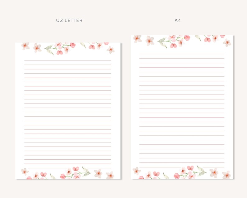 May include: Two sheets of lined stationery, one US Letter size and one A4 size, are displayed. Both sheets feature a delicate watercolor floral design of pink blossoms and green leaves at the top and bottom. The paper has horizontal pink lines.