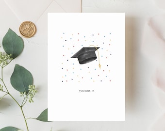 May include: A white card with a black graduation cap and colorful confetti. The text "You Did It!" is printed on the card.
