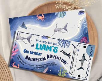 May include: An invitation for a 6th birthday party with an aquarium theme. The design features watercolor illustrations of sharks, fish, and other marine life. The invitation is in the shape of a ticket and includes the party details.