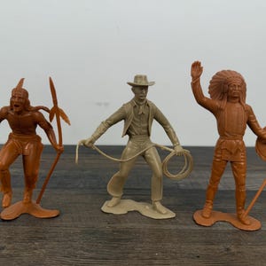 May include: A set of three ceramic mugs with a speckled, matte finish. The mugs are in shades of cream, light gray, and dark gray. Each mug has a simple, minimalist design, perfect for coffee or tea.