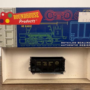 May include: A black HO gauge model train car inside its original box. The box is blue with a train illustration and the text "ROUNDHOUSE Products". The model train car has the text "SERIES 6 RIVERSIDE WEST 188".