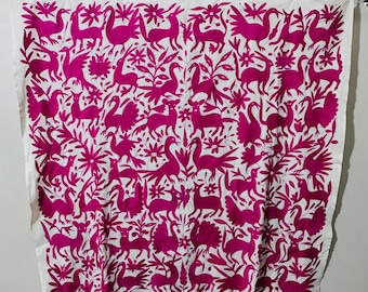 May include: A white fabric panel featuring a dense, repeating pattern of magenta embroidered animals and floral motifs. The design includes various birds, deer, and rabbits interspersed with leafy branches and flowers, all rendered in a vibrant pink.