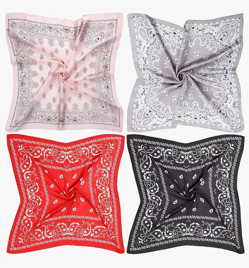 May include: Four bandanas in different colours: pink, grey, red, and black. Each bandana has a white paisley pattern.