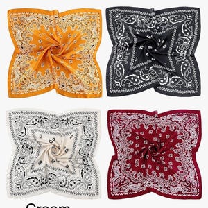 May include: Four square bandanas in different colours: yellow, black, cream, and red. Each bandana has a white paisley pattern.