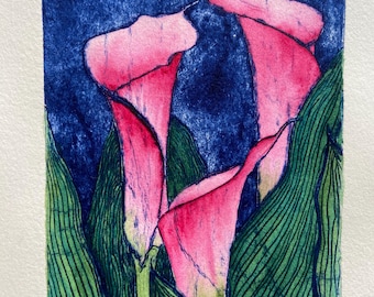 May include: A close-up of a print of three pink calla lilies against a dark blue background. The lilies are surrounded by green leaves with a detailed line pattern.