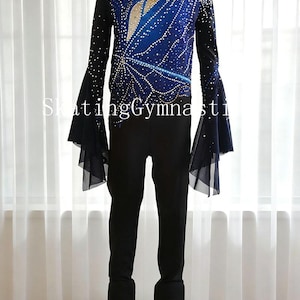 May include: A figure skating outfit featuring a blue and black top with a jewel-like design and long sleeves. The outfit includes black pants and white ice skates. The text "SkatingGymnasti" is visible on the image.