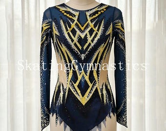 May include: A long-sleeved leotard in deep navy blue featuring intricate gold and silver sequin patterns across the chest and sleeves. The garment includes sheer nude mesh panels at the sides and a jagged hemline with navy blue fabric accents.