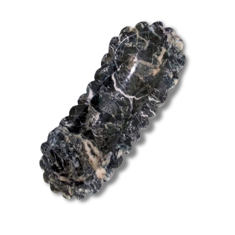 May include: A black and white marble serving dish with a scalloped edge. The dish is shaped like a long oval and has a smooth, polished surface.