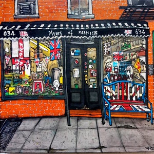 May include: A storefront with a black awning that reads "Myers of Keswick" and a red, white, and blue striped bench in front. The storefront windows are decorated with Union Jack flags and other festive decorations. The storefront is brick with a number "634" above the awning.