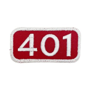May include: A rectangular red patch with white embroidered numbers "401". The patch has a white stitched border. The numbers are large and centered on the patch.
