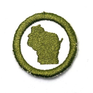May include: Green embroidered patch with a white outline, featuring the state of Wisconsin in the center.