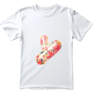 May include: White t-shirt featuring a floral print of two pills.