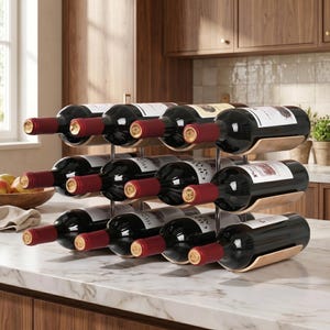 May include: A wine rack made of metal and wood holds twelve bottles of red wine. The bottles are arranged in three rows of four, with the labels facing forward. The rack is on a marble countertop.